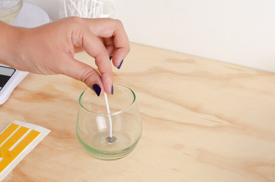 Woman putting wick for soy candle. Small businesses, female businesses, organic, sustainable. Vegetable waxes. Candlewick