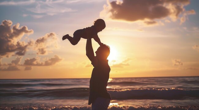 Silhouette of Father holding son on the beach, Happy Father's Day.