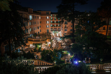 Elegant outdoor dining area at luxury urban restaurant surrounded by classic buildings. Warm...