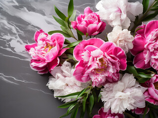 Fuchsia and white peony bouquet is showcased beautifully on a grey concrete backdrop