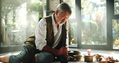 Person, herbal medicine and shaman for ritual for natural healing with spiritual alter with magic, herbs and apocathery. Male naturopath or holistic or traditional healer for sacred cleansing of mind