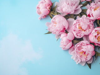 Pink peonies form a frame on punchy pastel blue, offering text space from above