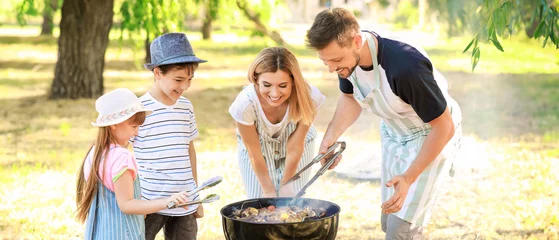 Zelfklevend Fotobehang Happy family cooking tasty food on barbecue grill outdoors © Pixel-Shot