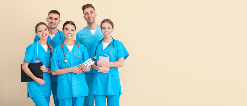 Group of medical students on light background
