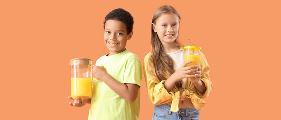 Little children with cup and jug of fresh citrus juice on orange background - obrazy, fototapety, plakaty