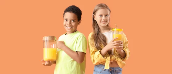 Zelfklevend Fotobehang Little children with cup and jug of fresh citrus juice on orange background © Pixel-Shot