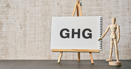 There is notebook with the word GHG. It is an abbreviation for Greenhouse Gas as eye-catching image.