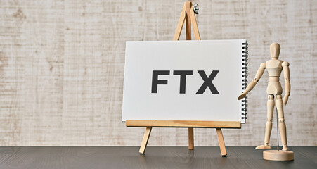 There is notebook with the word FTX. It is an abbreviation for FTX as eye-catching image. - obrazy, fototapety, plakaty