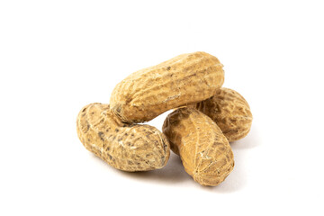 a macro closeup of several roasted peanuts in the shell isolated on white