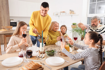 Big family having dinner in kitchen