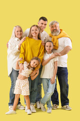 Fototapeta na wymiar Big family hugging on yellow background