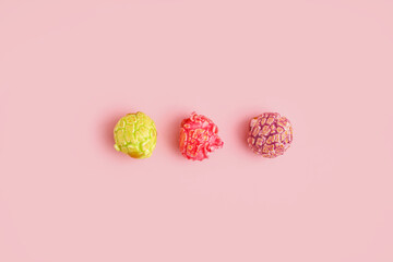 Sweet colorful popcorn on pink background