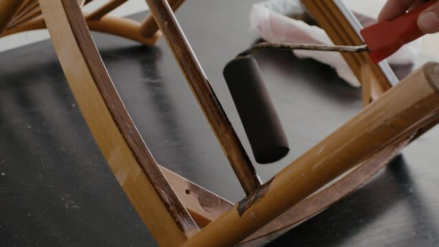 Restoration of a wooden chair. Covering with dark varnish. Close-up. Vintage things. High quality 4k footage