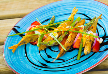 Fried in batter sprats with creamy ginger sauce on cushion of sweet tomatoes, greens and balsamic...