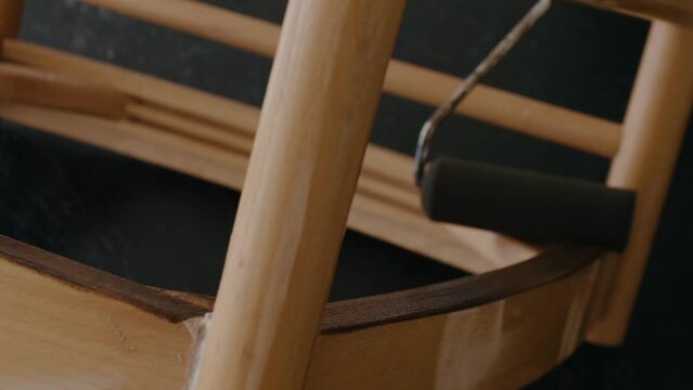 Restoration of a wooden chair. Covering with dark varnish. Close-up. Vintage things. High quality 4k footage