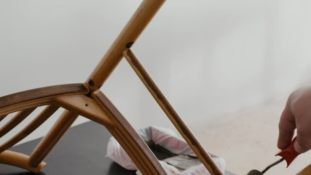 Restoration of a wooden chair. Covering with dark varnish. Close-up. Vintage things. High quality 4k footage