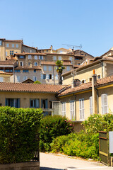 Traditional multi-level houses on narrow street of small French town of Auch on sunny summer day