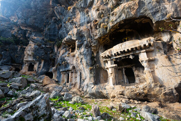 Lycian rock hewn tombs carved into mountainside in ancient Pinara city, Mugla Province, Turkey