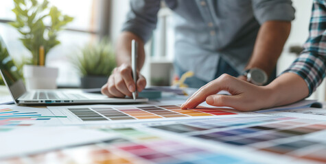 Creative Teamwork: Close-Up of Designers Analyzing Color Palettes for Marketing Strategy in bright office