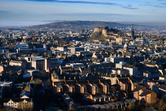 A view of historic row houses and Edinburgh Castle from Arthur's Seat, a volcanic peak overlooking Edinburgh, Scotland.