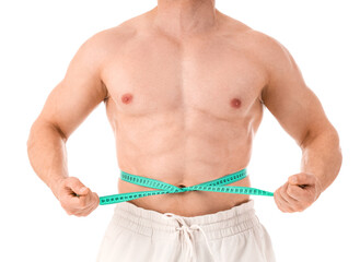 Male bodybuilder measuring his belly on white background, closeup