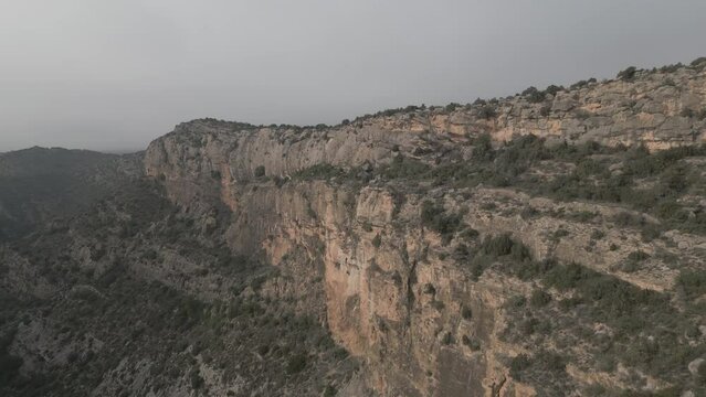 Aerial view of Camarasa in Catalonia. foggy Mountains and Via Ferrata route. foggy Mountains full of caves. drone shots flying through the clouds, High quality 4k footage