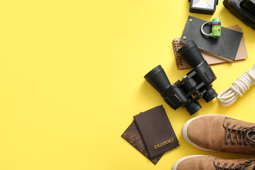 Set of travel items, passports and notebooks on yellow background