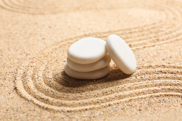 Fototapeta na wymiar White spa stones on light sand