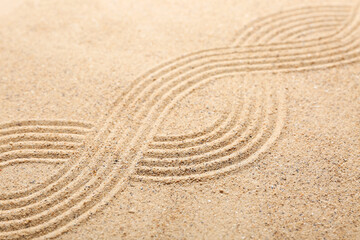 Fototapeta na wymiar Texture of sand with pattern. Zen concept