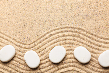Fototapeta na wymiar White pebbles on light sand