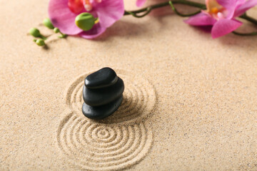 Fototapeta na wymiar Spa stones with orchid on sand with pattern