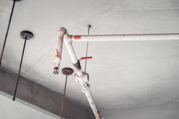 White and Red Fire Protective Water Pipeline and Sprinkler system on concrete Ceiling, Inspecting...