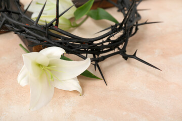 White lilies and crown of thorns on light background