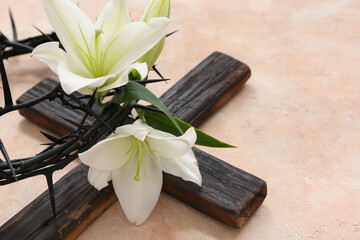 White lilies, crown of thorns and cross on light background