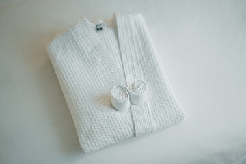 white bathrobe on the bed