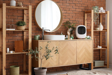 Small cosmetic refrigerator on wooden chest of drawers near brick wall in bathroom