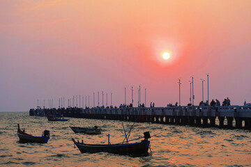 Sunset over the long bridge and boats at the sea, Bangsaen, Chonburi Province, Thailand