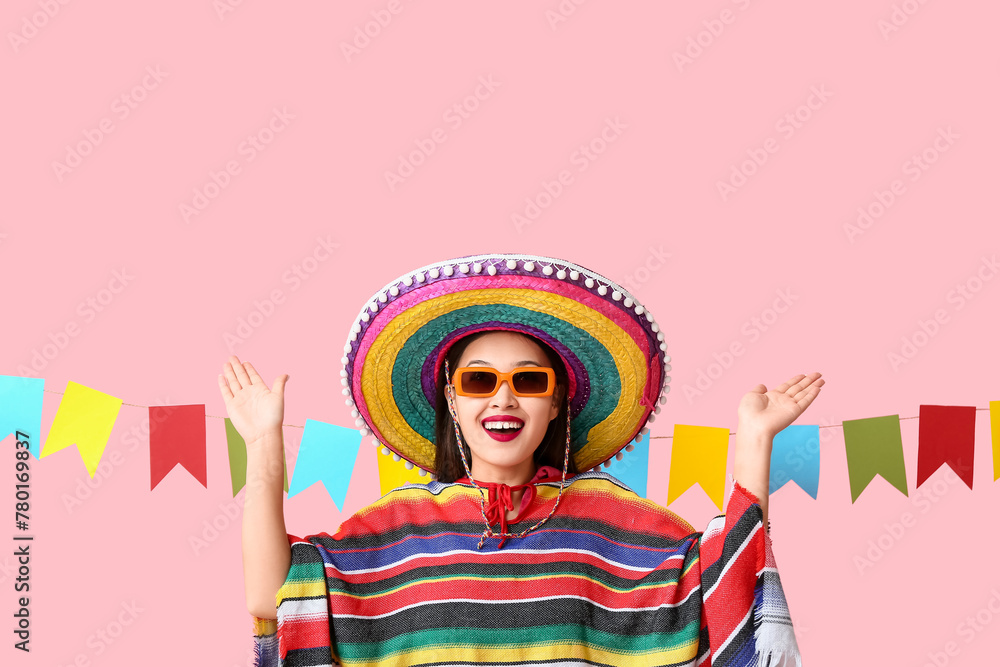 Sticker Happy young woman in Mexican sombrero hat and poncho on pink background