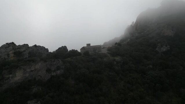 Aerial view house on top of the Mountain, surrounded by cloud, Camarasa, Catalonia. 