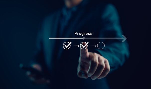 Businessman or manager touching on checklist to tick correct mark with progressive loading status to remind work task progressive for project develop management and tracking concept.