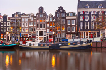 Fototapeta premium Amsterdam canal Singel with typical dutch houses during morning blue hour, Holland, Netherlands.
