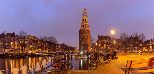 Panorama of Amsterdam canal Oudeschans and tower Montelbaanstoren, Holland, Netherlands.