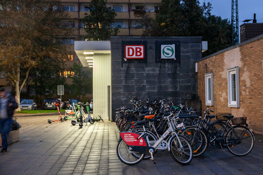 COLOGNE, GERMANY - NOVEMBER 12, 2022: entrance to koln mulheim bahnhof in Cologne with bicycles parked in front at night. It's a major train station of the Cologne S-Bahn suburban system.