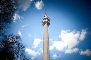 Panorama of the avala hill skyline with a focus on Avala tower, or Avala toranj,with a blue sky. It is a TV tower and broadcasting antenna in the suburbs of Belgrade, Serbia. - obrazy, fototapety, plakaty