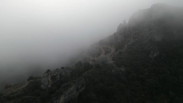 Aerial view house on top of the Mountain, surrounded by cloud, Camarasa, Catalonia. 