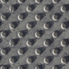 Seamless polka dot pattern. Square fragment of street flooring, plaster bas-relief, concrete stone gray wall. Home decoration. Concept of architecture, sculpture, sculpting, urbanism, brutality. City