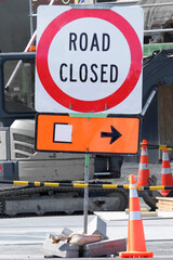 Road Closed sign at the beginning  of street closed for repairs.