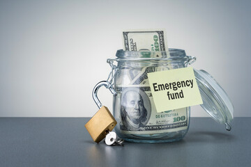 Emergency fund in the glass jar with cash.