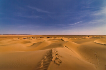 Fototapeta na wymiar A panoramic sand dune near the desert camp at Mhamid el Ghizlane in Morocco wide