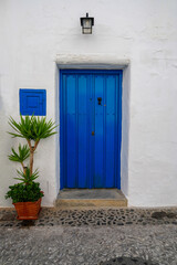 Fototapeta na wymiar Bright blue door in white village of Frigiliana 